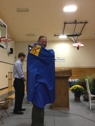 Lyon Co. Sheriff Al McNeil receives his Social Justice SuperHero cape